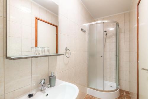 a bathroom with a sink and a shower at Citylife Rooms in Mosonmagyaróvár