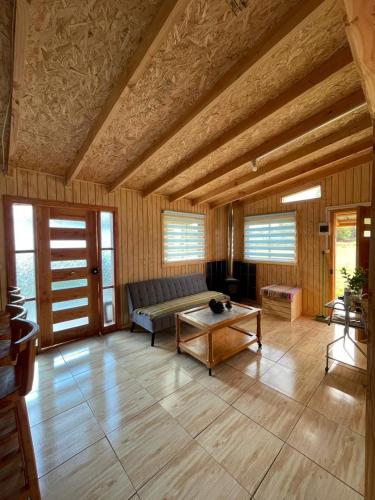 a living room with a couch and a coffee table at Cabaña By Casur in Panguipulli