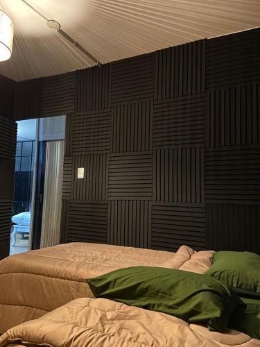 a bedroom with two beds and a wall of wood at Hostel Nueva cordoba Subte Uno in Cordoba