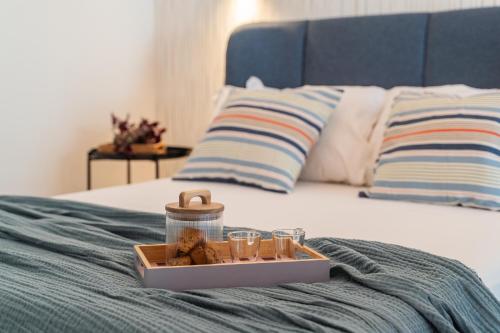 a tray of food and glasses on a bed at SMERALDO ACQUAMARINA Waterfront in Roseto degli Abruzzi