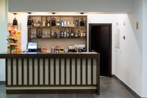 a bar in a room with a wall of bottles at Hotel Freixo Douro Superior in Freixo de Espada à Cinta
