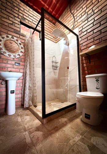 カタマヨにあるCasa familiar La Bendita Rincón Mágicoのバスルーム(ガラス張りのシャワー、トイレ付)