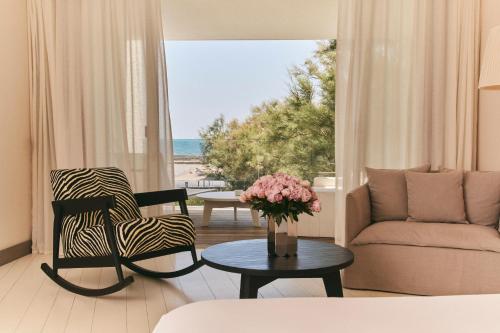 a living room with a view of the beach at Hôtel Plage Palace & Spa in Palavas-les-Flots