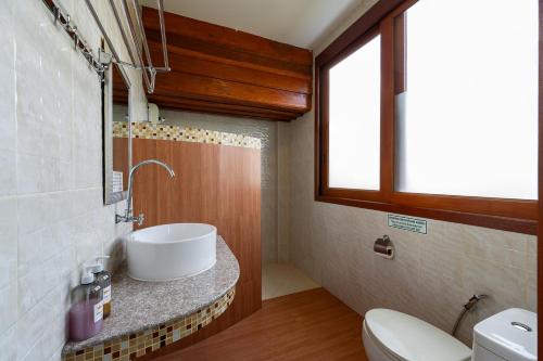 a bathroom with a sink and a toilet at Romsak Lanna Resort in Chiang Mai