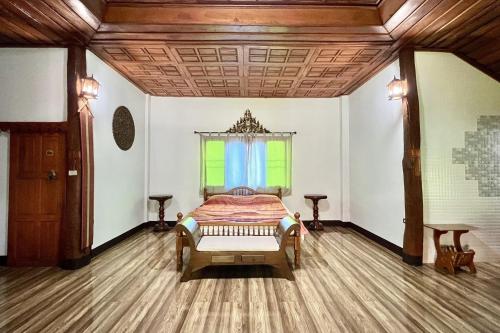 a bedroom with a bed and a window at Romsak Lanna Resort in Chiang Mai