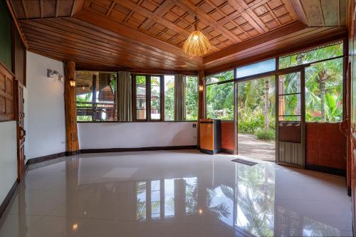 a large room with a glass floor and windows at Romsak Lanna Resort in Chiang Mai