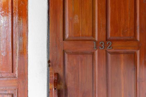 a wooden door with the on it at Romsak Lanna Resort in Chiang Mai