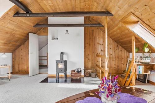 a living room with a fireplace and wooden walls at 4091-Borre-Klintevej-491 in Borre