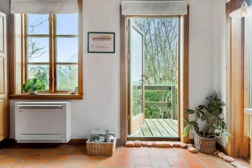 a room with a large window and a kitchen with a stove at 4091-Borre-Klintevej-491 in Borre