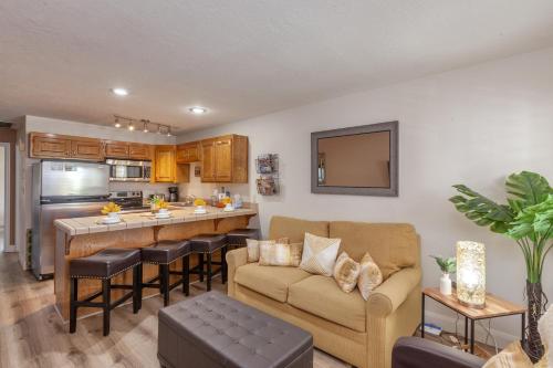 a living room with a couch and a kitchen at LP 124 Mesa Views, Grill, Cable, Great Las Palmas Amenities, and Fully Stocked Kitchen in St. George