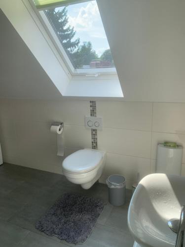 a bathroom with a toilet and a sink and a window at Haus Matti in Meuro
