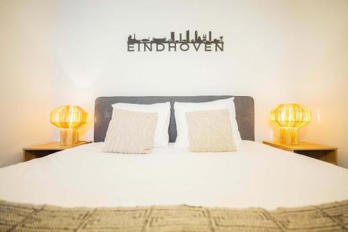 a bedroom with a white bed with two lamps at Upscale 90m2 Two Bedroom Apartment - KS8B in Eindhoven