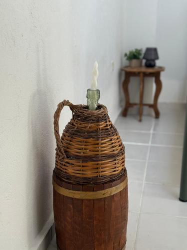 a basket with a candle on top of it at Vigliata Sidirounta Traditional Stonehouse in Chios