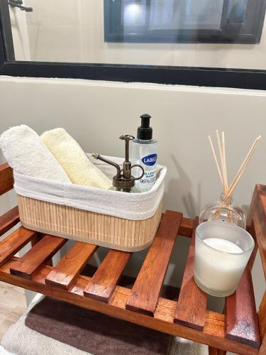 a bathroom sink on a wooden pallet with a bowl of milk at La brise Marine in Lomé