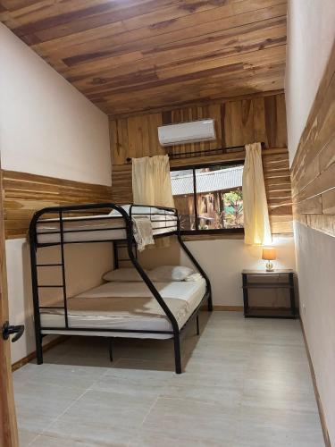 a bunk bed in a room with a wooden ceiling at Rusteak Living Retreat in natural and peaceful setting in Canafistula in Cañafístula