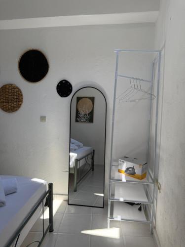 a room with a mirror and a bed in a room at Vigliata Sidirounta Traditional Stonehouse in Chios