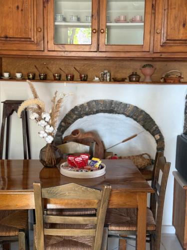 a dining room with a table with a monkey on the wall at Vigliata Sidirounta Traditional Stonehouse in Chios
