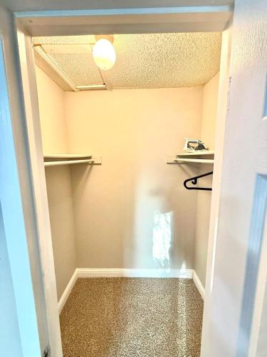 a walk in closet with shelves and a hallway at Cozy retreat 1Br 1Ba near hospital and tollway in Addison