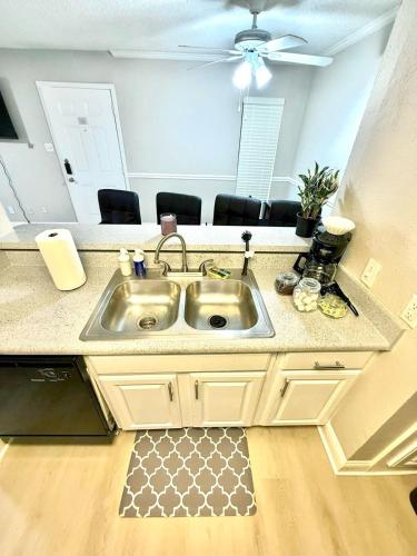 a kitchen with a sink and a counter top at Cozy retreat 1Br 1Ba near hospital and tollway in Addison
