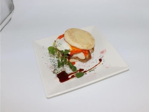 a sandwich on a white plate on a table at HOTEL felice Osaka Itami Airport - Vacation STAY 54193v in Toyonaka