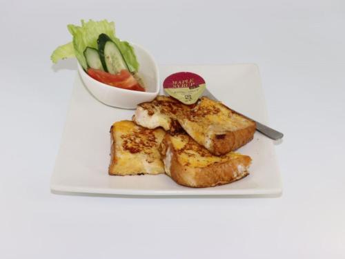 a plate of food with toast and a bowl of vegetables at HOTEL felice Osaka Itami Airport - Vacation STAY 54193v in Toyonaka