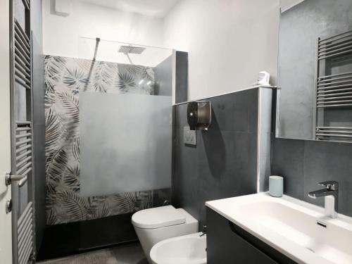 a bathroom with a toilet and a sink and a shower at Il Bacio di Roma in Infernetto