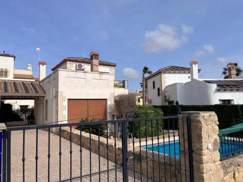 a house with a fence and a swimming pool at Spanish Pool vacation LFG in Algorfa