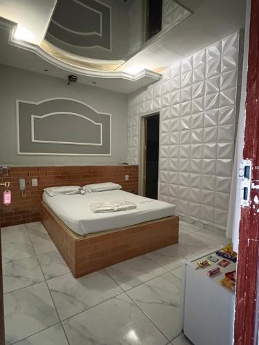 ein Schlafzimmer mit einem Bett in einem Zimmer in der Unterkunft Motel Fascinação in Contagem