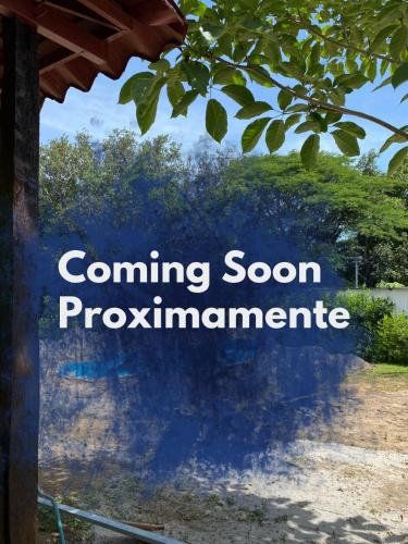 a sign that reads coming soon programmeline with a tree at Tiquisia Lodge in Curubandé