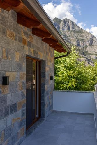 a stone house with a view of the mountains at Sofra Kelmendit in Tamarë