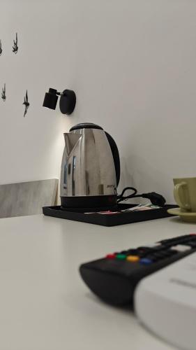 a toaster sitting on a table next to a remote control at Swallow Room Holidays in Massa Lubrense