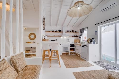 a kitchen and living room with a couch and a table at Abrigo da Sorna in São Marcos do Campo