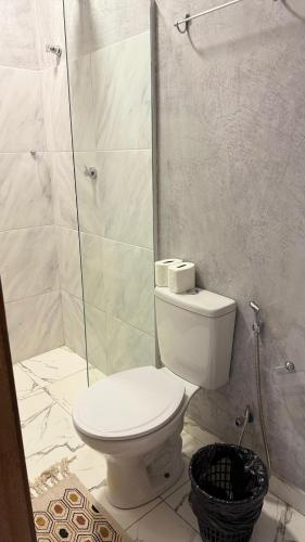 a white bathroom with a toilet and a shower at Pousada Porto de Paz - Noronha in Fernando de Noronha