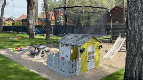 a play area with a playground with a slide at Mazurska Odsapka Apartamenty in Martiany