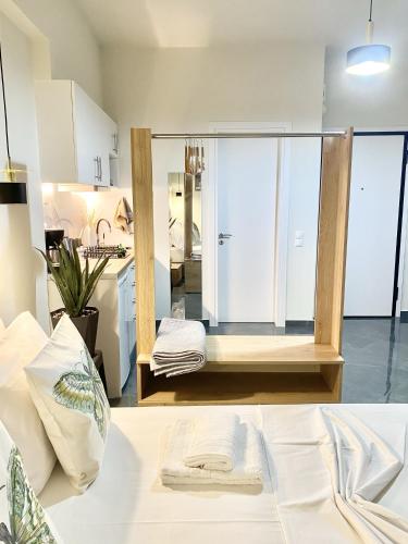 a room with a kitchen and a large mirror at ATHENIAN Vibes in Athens