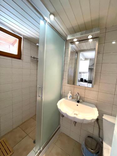 a bathroom with a sink and a mirror at Hidden Gem at Kiani Beach in Kalyves