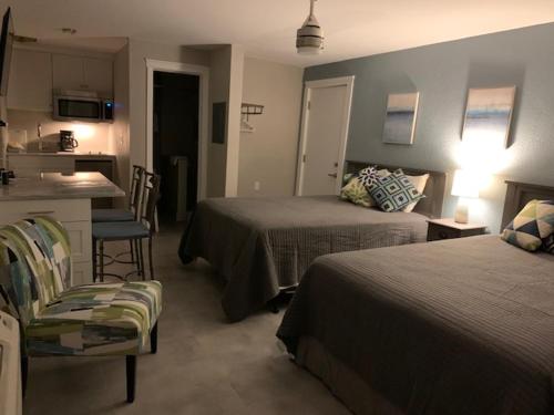 a hotel room with two beds and a kitchen at A Beach Retreat on Casey Key in Venice