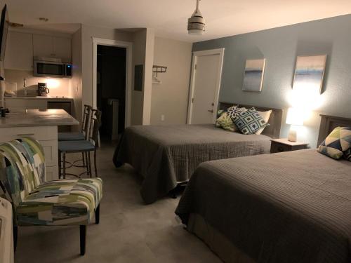 a hotel room with two beds and a kitchen at A Beach Retreat on Casey Key in Venice