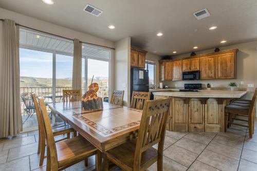 a kitchen and dining room with a table and chairs at 2012 LP PS4, Private Balcony with Beautiful Mountain Views, and Great Clubhouse Amenities in St. George