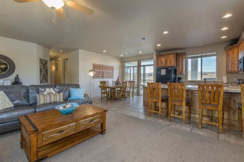 a living room with a couch and a table at 2012 LP PS4, Private Balcony with Beautiful Mountain Views, and Great Clubhouse Amenities in St. George