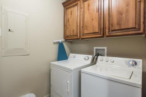 a laundry room with a washer and dryer at 2012 LP PS4, Private Balcony with Beautiful Mountain Views, and Great Clubhouse Amenities in St. George