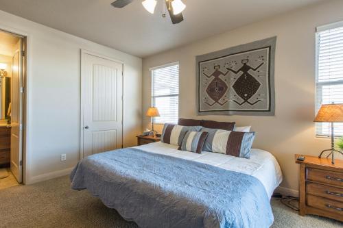 a bedroom with a large bed and two windows at 2012 LP PS4, Private Balcony with Beautiful Mountain Views, and Great Clubhouse Amenities in St. George