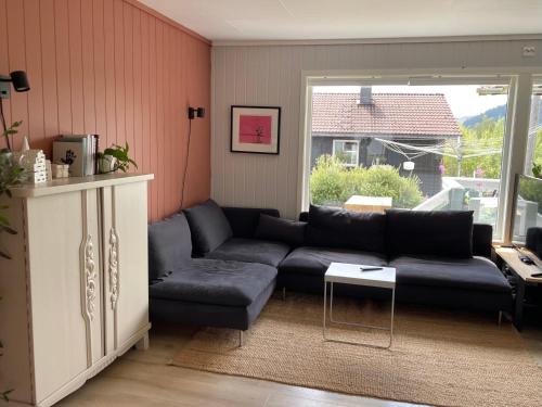 a living room with a couch and a table at Koselig Enebolig in Iveland