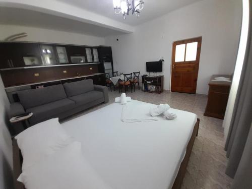 a bedroom with a large white bed and a couch at Albert Guest House in Borsh