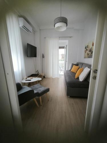 a living room with a couch and a table at Deppy's House in Vasiliki