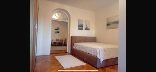 a bedroom with a bed and an arched doorway at Apartament Central Muma in Sibiu
