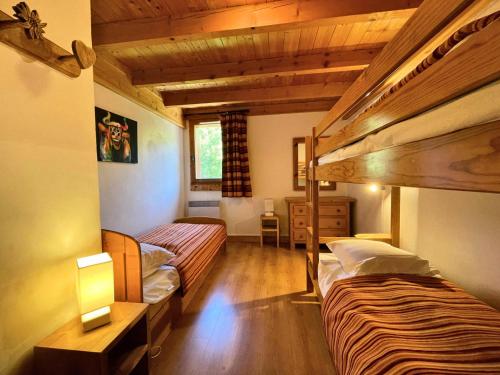 Cette chambre dispose de 2 lits superposés et de plafonds en bois. dans l'établissement Résidence Courmayeur - Appartement 8/10 personnes 81m² aux Menuires MAE-4334, aux Menuires