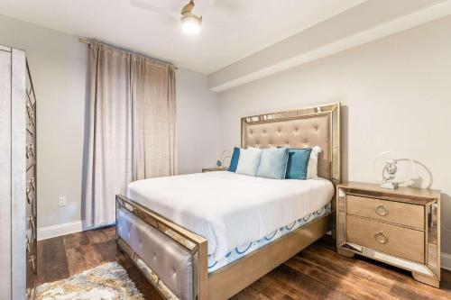 a bedroom with a large bed with blue pillows at Lake Views At Blue Heron in Orlando