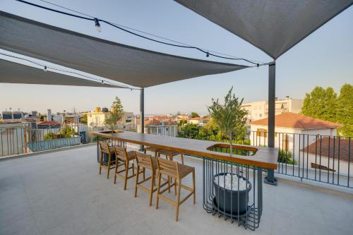 a patio with a table and chairs on a roof at Secret Garden Studios in Mytilini