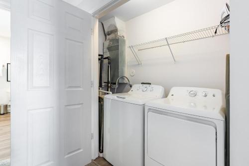 a white laundry room with a washer and dryer at Landing Bellingham Park - Wilmington in Wilmington